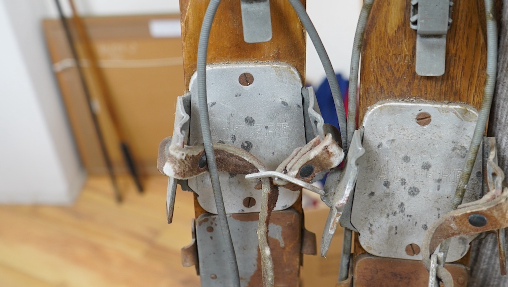 A pair of early 20th century wooden skis with Kandahar metal bindings. 207cm long. Condition - bindings rusty in places leather strapping worn in places, skis appear good but are untested